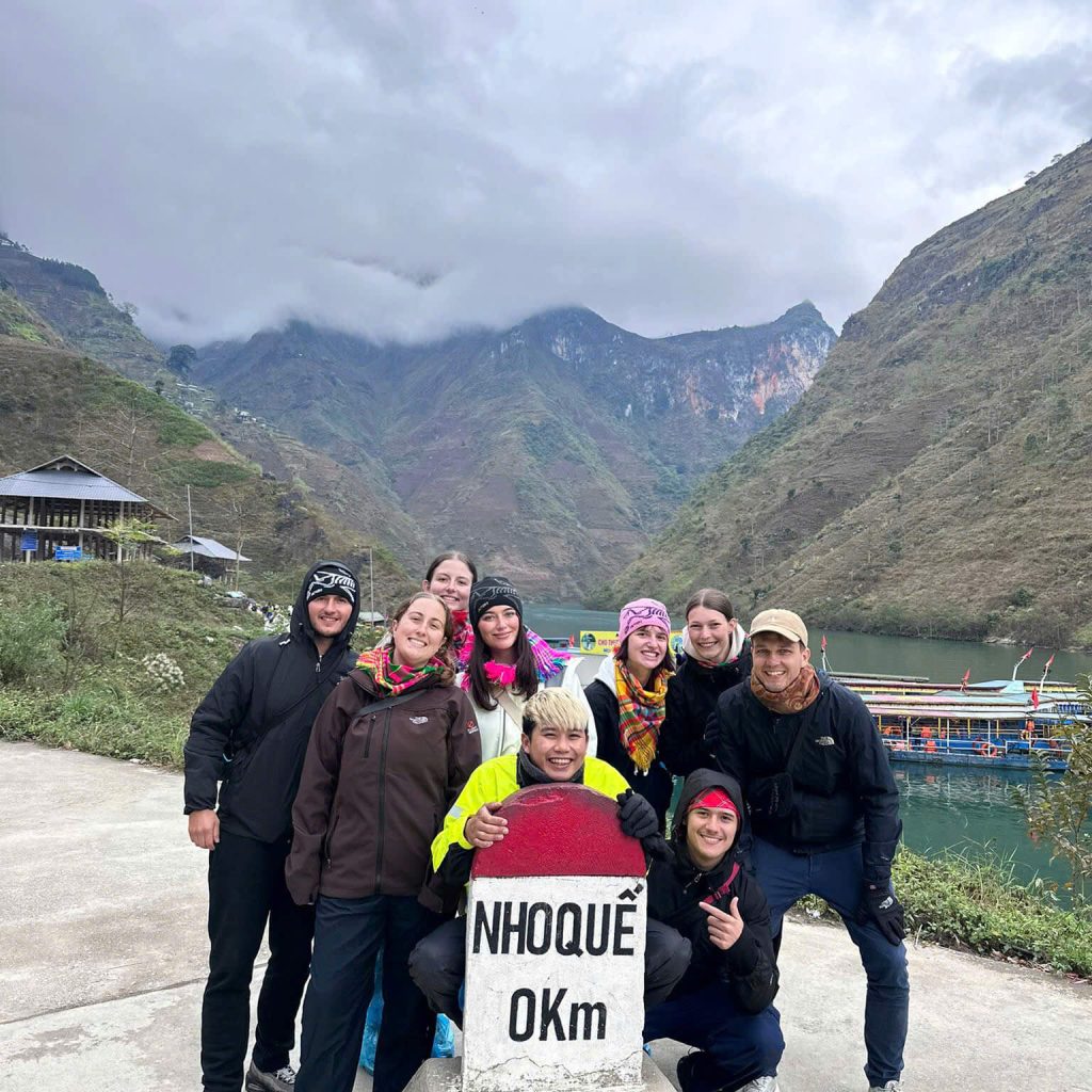 Nho Que 0km milestone before taking a scenic boat ride through Tu San Canyon